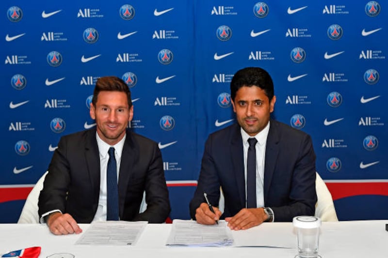 Lionel Messi sign his two-year contract with Paris Saint-Germain president Nasser Al Khelaifi on August 10, 2021 in Paris, France.