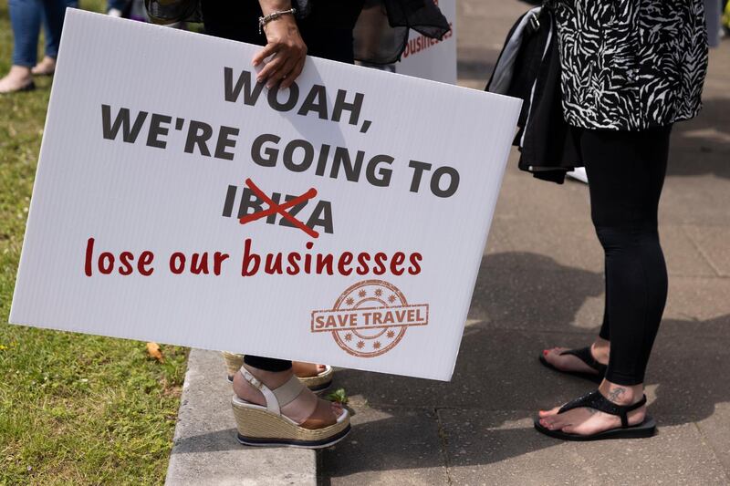 A protester holds a sign which reads 'We're going to lose our business'. Getty Images