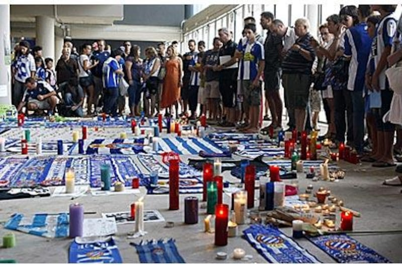 Espanyol supporters observe a moment of silence during a memorial for Daniel Jarque inside the Cornella-El Prat stadium in Barcelona.