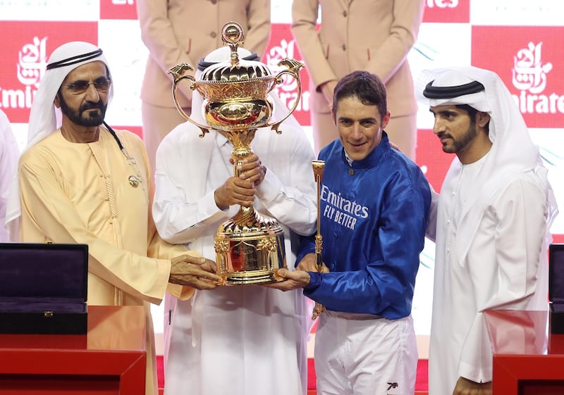 Sheikh Mohammed bin Rashid lifts the trophy with jockey Christophe Soumillon after winning the Dubai World Cup on Saturday. Pictured with Sheikh Hamdan bin Rashid and Sheikh Hamdan bin Mohammed, Crown Prince of Dubai. Abdullah Jadallah / Reuters