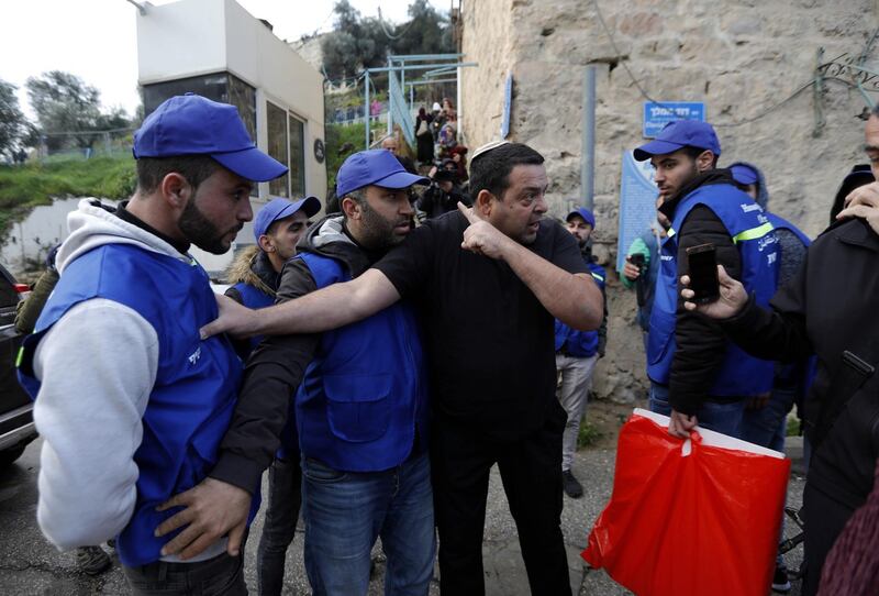 An Israeli settler argues with Palestinians wearing blue vests marking them as observers during a protest against the end of the mandate for the civilian Temporary International Presence in Hebron. EPA