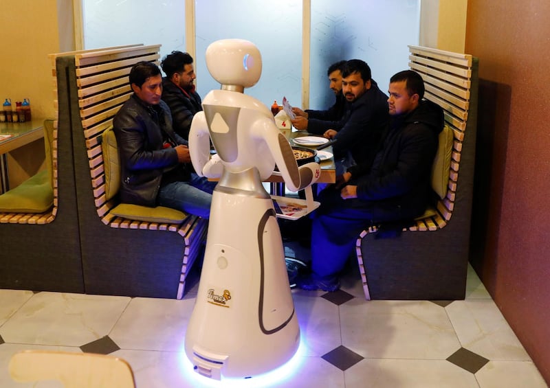 Timea brings food to a table at the Times Fast Food restaurant in Kabul, Afghanistan. Reuters