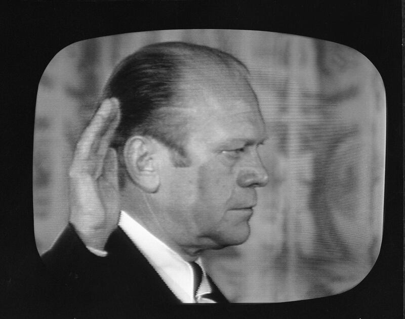 Screen capture shows American politician Gerald Ford with his right hand raised as he is sworn in as the 38th president of the United States, East Room, White House, Washington, DC, August 9, 1974. Ford replaced Richard Nixon who resigned to avoid a potential impeachment. (Photo by CBS Photo Archive/Getty Images)