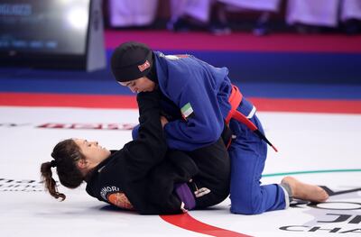 UAE's Maitha Shraim, in blue, was narrowly beaten by Switzerland's Sabrina Migliozzi at Zayed Sports City’s Jiu-Jitsu Arena in Abu Dhabi. Pawan Singh / The National