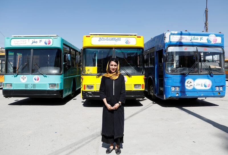 Karim poses for photos in front of the mobile library buses.