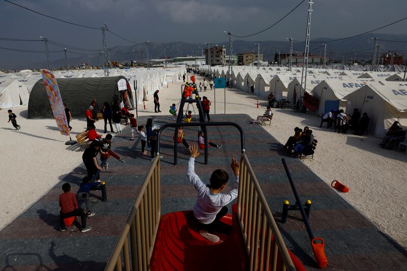 Children play at a playground in the Orhanli tent city following the deadly earthquake in Antakya, Hatay province. Reuters