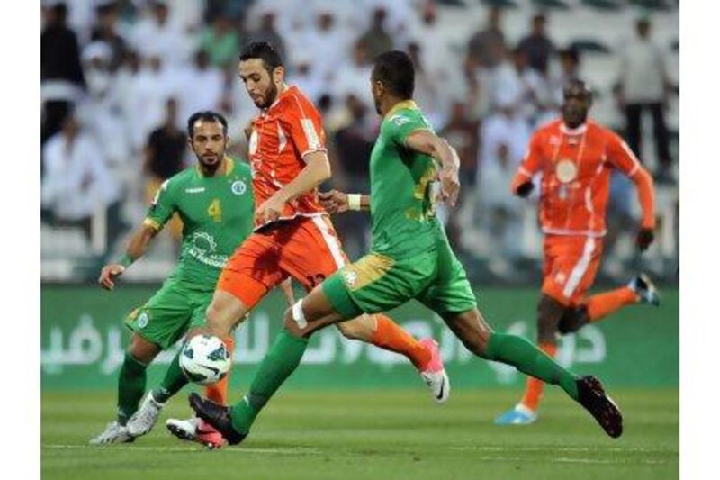 Ajman's Driss Fettouhi looks to score during the semi-Final Pro League football match between Al Shabab (green) v Ajman (orange) at Shabab's Maktoum Bin Rashid Al Maktoum Stadium on 25.03.2013. Ashraf Umrah / Al Ittihad