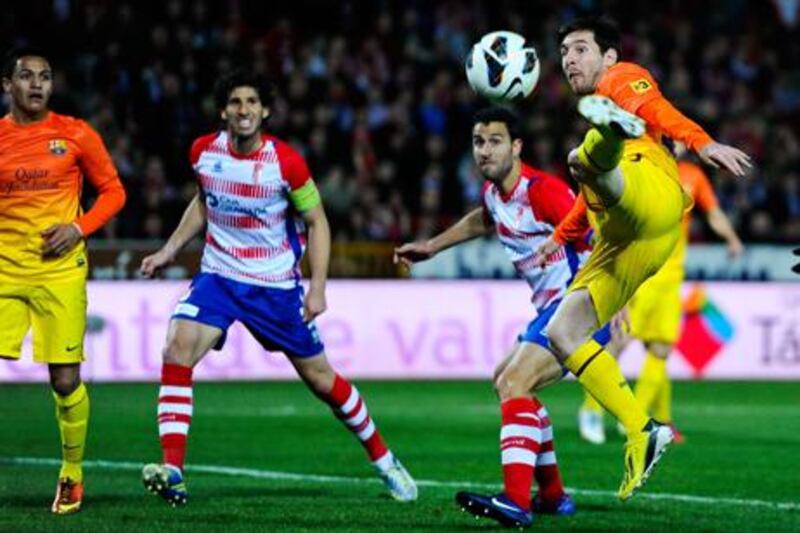 Lionel Messi scissor kicks the ball during Barcelona's win at Granada.