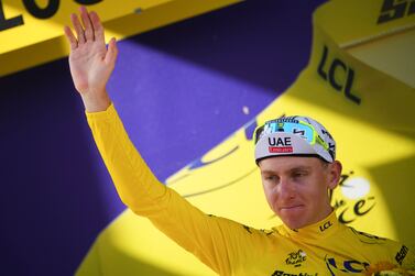 Slovenia's Tadej Pogacar, wearing the overall leader's yellow jersey, celebrates on the podium after the second stage of the Tour de France cycling race over 199. 2 kilometers (123. 8 miles) with start in Cesenatico and finish in Bologna, Italy, Sunday, June 30, 2024.  (AP Photo / Daniel Cole)