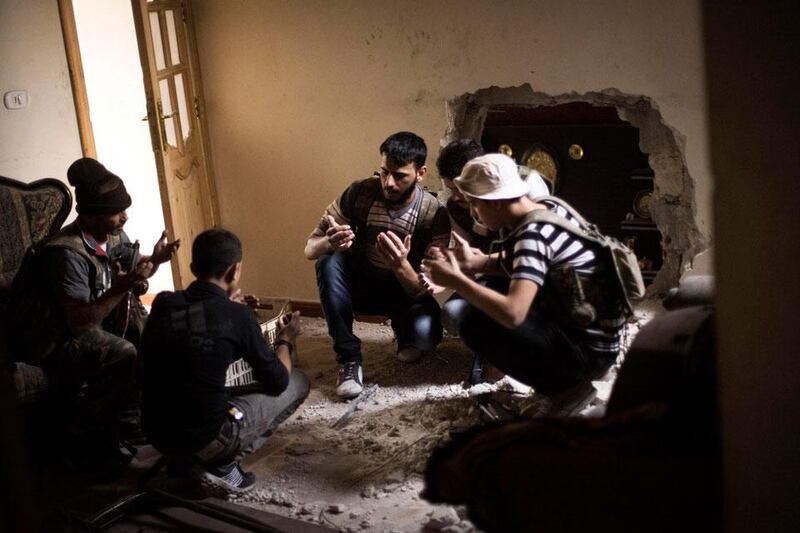 Free Syrian Army fighters pray before beginning an operation against the Syrian Army positions in the Amriya district in Aleppo.