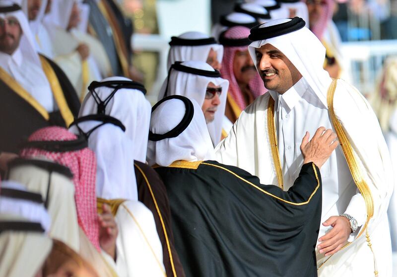 epa03758128 (FILE) A file photo dated 18 December 2012 shows Qatari Crown Prince, Sheikh Tamim Bin Hamad Al-Thani (R) arriving for the military parade to mark Qatar's National Day celebration, in Doha, Qatar. The Doha-based Al Jazeera broadcaster reported on 24 June 2013 that Qatari Emir Sheikh Hamad bin Khalifa Al Thani has told members of the royal family that he plans to hand over power to his son, Sheikh Tamim. The royal court said the emir will address the nation on 25 June without elaborating.  EPA/STR *** Local Caption ***  03758128.jpg