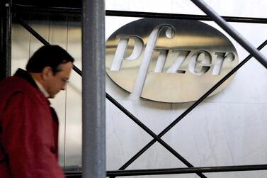A pedestrian walks past the Pfizer headquarters building in New York. When Pfizer and BioNTech announced on November 9 that their Covid-19 vaccine was 90 per cent effective, global stock markets responded by skyrocketing to record highs. EPA