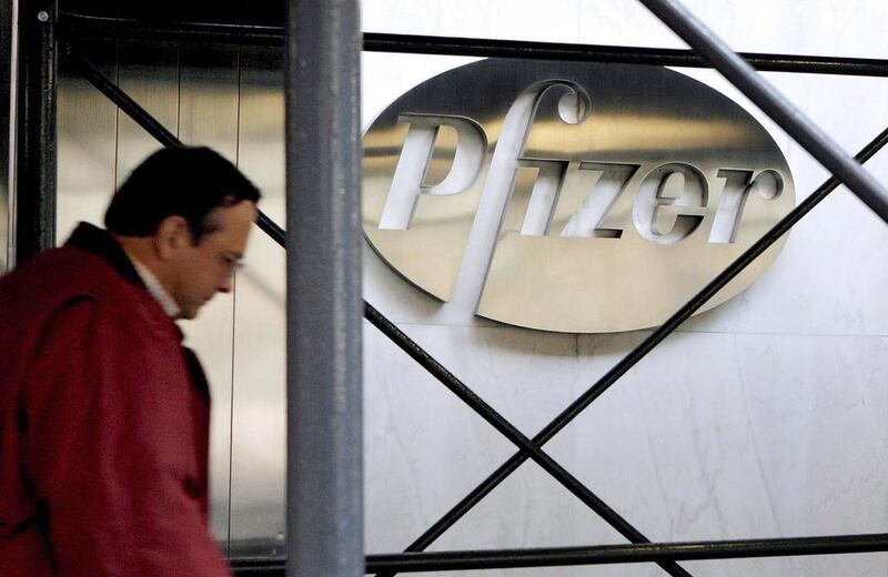 A pedestrian walks past the Pfizer headquarters building in New York. When Pfizer and BioNTech announced on November 9 that their Covid-19 vaccine was 90 per cent effective, global stock markets responded by skyrocketing to record highs. EPA