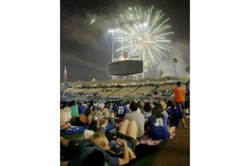 Fireworks at ballparks, such as this one in Los Angeles, draw crowds on the Fourth of July.
