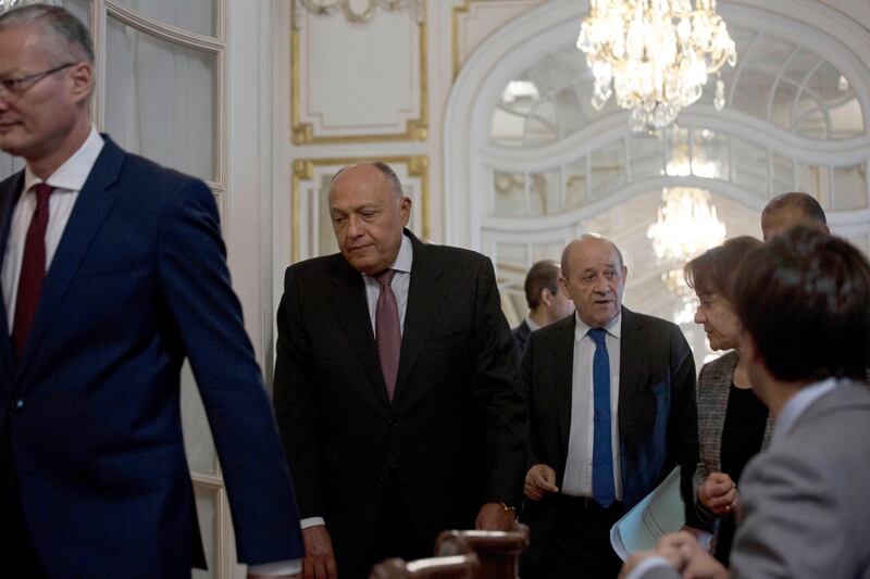 French Foreign Minister Jean-Yves Le Drian, right, and Egypt's Foreign Minister Sameh Shoukry, center, arrive for a joint press conference in Cairo, Egypt. AP Photo