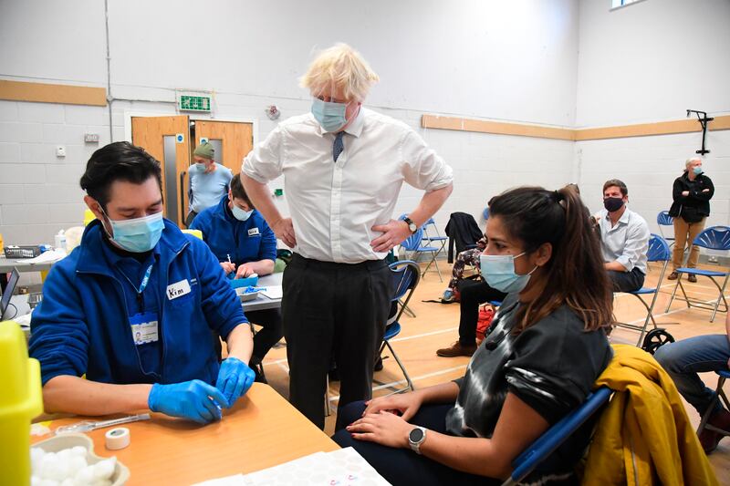 British Prime Minister Boris Johnson visits Stow Health vaccination centre, in Westminster, London. At least one person in the UK has died with the Omicron variant. AP Photo