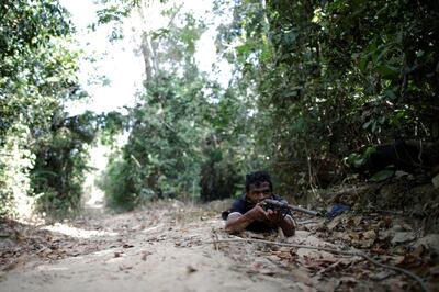 Indigenous leader Paulo Paulino Guajajara holds a gun during the search for illegal loggers on Arariboia indigenous land near the city of Amarante, Maranhao state, Brazil, September 11, 2019. Picture taken September 11, 2019. REUTERS/Ueslei Marcelino