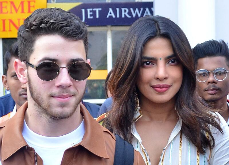 Bollywood actress Priyanka Chopra and singer Nick Jonas wave as they arrive at the airport in ahead of their wedding on November 29, 2018. Photo: Reuters