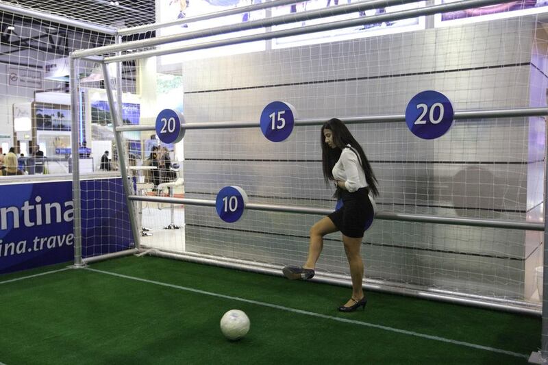 A visitor kicks a football during a contest at the Argentina showroom. Jaime Puebla / The National
