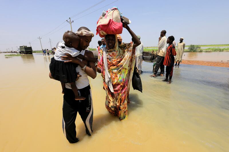 Crossing the floodwaters in Al Manaqil, in Sudan's Al Jazira state. Reuters