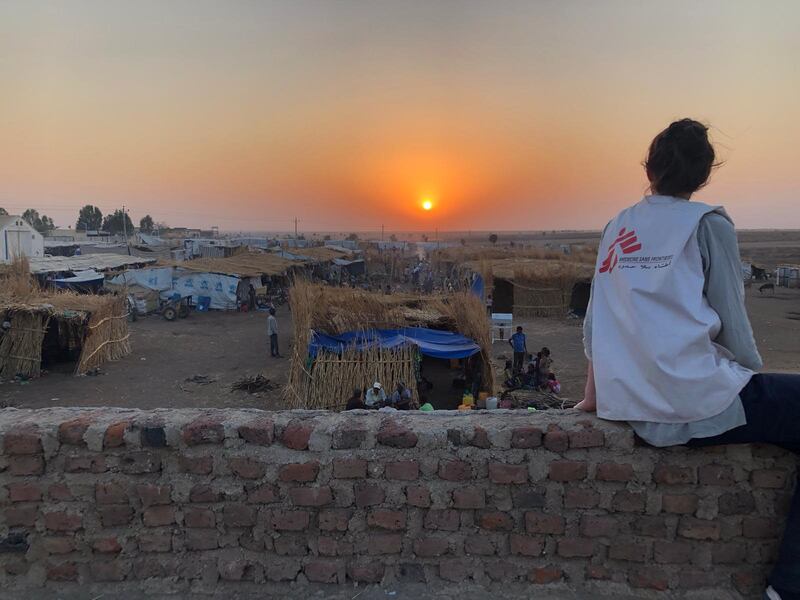An MSF staff overlooking the reception area in Hamadyet where more than 10,000 are living as they await transfer to a permanent  camp location. Courtesy MSF