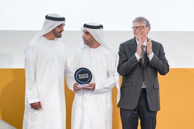 AL MARYAH ISLAND, ABU DHABI, UNITED ARAB EMIRATES - November 15, 2017: HH Sheikh Mohamed bin Zayed Al Nahyan, Crown Prince of Abu Dhabi and Deputy Supreme Commander of the UAE Armed Forces (L), presents a REACH award to HE Abdullah Khalifa Al Ghafli (C), during the Global Health Forum. Seen with Bill Gates, Co-chair and Trustee of Bill & Melinda Gates Foundation (R).

( Hamad Al Kaabi / Crown Prince Court - Abu Dhabi )
---