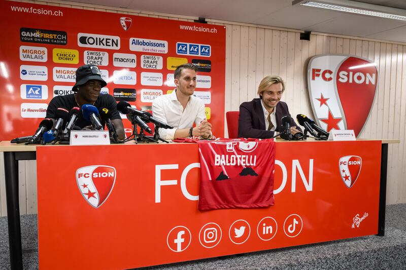 Mario Balotelli with FC Sion communications manager Baptiste Coppey  and sport director Barthelemy Constantin during the striker's press conference at the Stade de Tourbillon. EPA