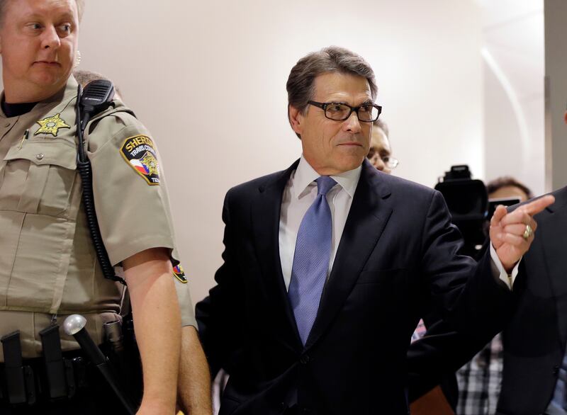 Former Texas governor Rick Perry arrives at the Blackwell Thurman Criminal Justice Centre for booking, in Austin, Texas. AP