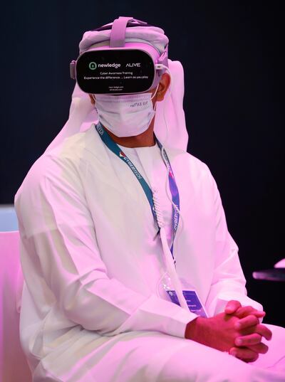 epa09116673 A participant tries out a VR (Virtual Reality) program during the Cybertech Global in the Gulf emirate of Dubai, United Arab Emirates, 05 April 2021. The 8th edition of Cybertech Global international exhibition and conference is taking place for the first time in Dubai and runs until 07 April 2021.  EPA/ALI HAIDER