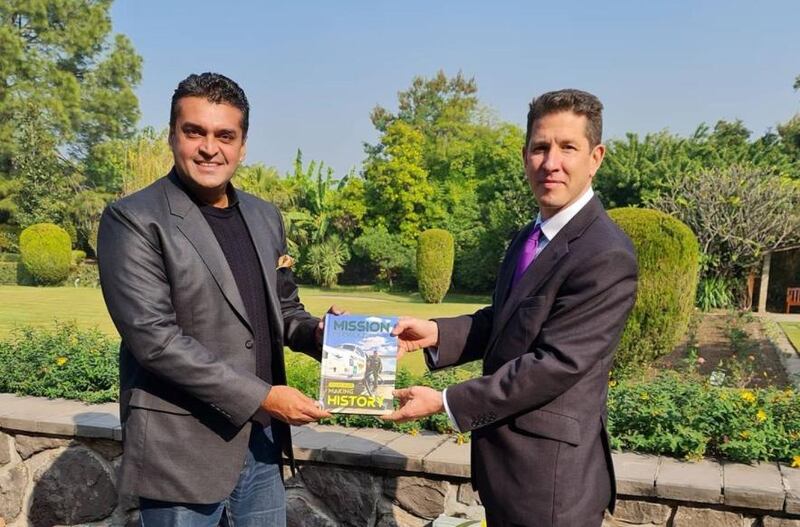 Fakhr-e-Alam presenting a book he wrote on 'Mission Parwaaz' to Christian Turner, the British High Commissioner to Pakistan.