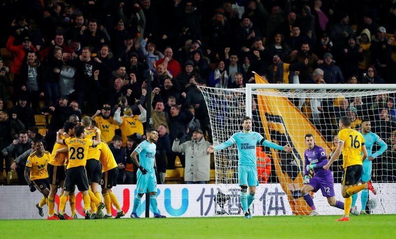 Soccer Football - Premier League - Wolverhampton Wanderers v Newcastle United - Molineux Stadium, Wolverhampton, Britain - February 11, 2019  Wolverhampton Wanderers' Willy Boly celebrates scoring their first goal with team mates as Newcastle players look dejected     REUTERS/Eddie Keogh  EDITORIAL USE ONLY. No use with unauthorized audio, video, data, fixture lists, club/league logos or "live" services. Online in-match use limited to 75 images, no video emulation. No use in betting, games or single club/league/player publications.  Please contact your account representative for further details.