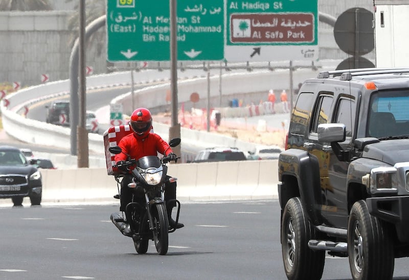 Dubai, U.A.E., October 7,  2018.  Delivery drivers at Dubai. Shot  on 06-09-18. --  A McDonald���s delivery driver tries to change lanes on Sheikh Zayed Road, Dubai.Victor Besa / The NationalSection: NA