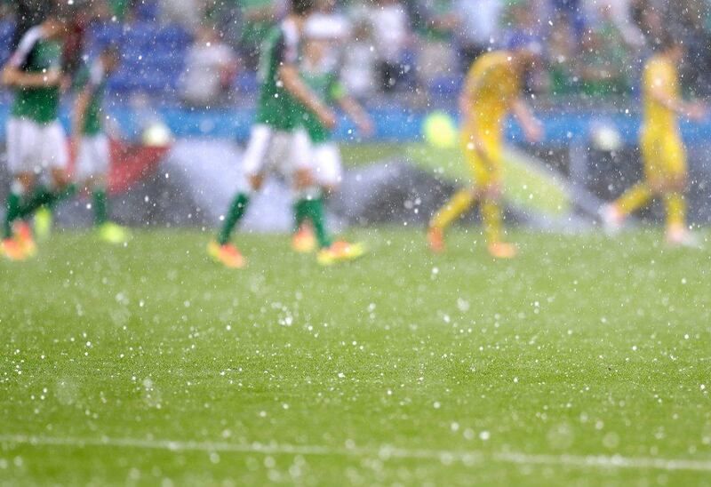 Hail falls briefly interrupting the game during the Euro 2016 Group C match between Ukraine and Northern Ireland at the Grand Stade in Decines, near Lyon, France. Pavel Golovkin / AP Photo