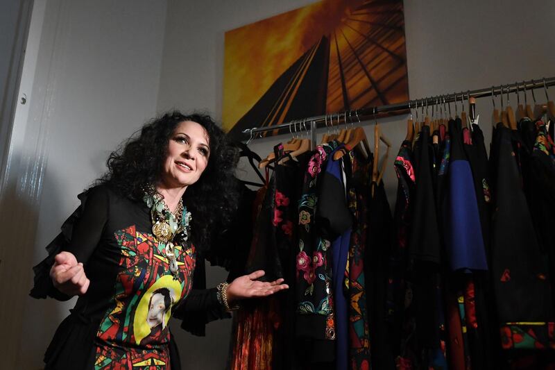 Hungarian Roma fashion designer Helen Varga stands in front of some designs. AFP