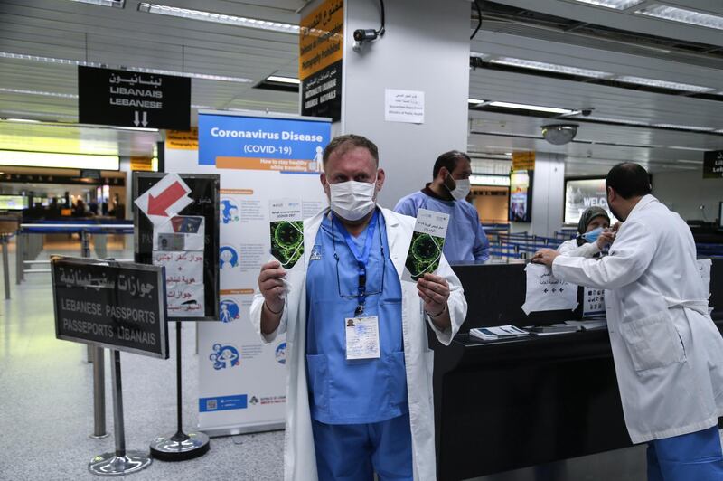 Lebanese doctor holds awareness brochures on coronavirus to be distributed on arriving passengers at Rafic Hariri international airport in Beirut. EPA