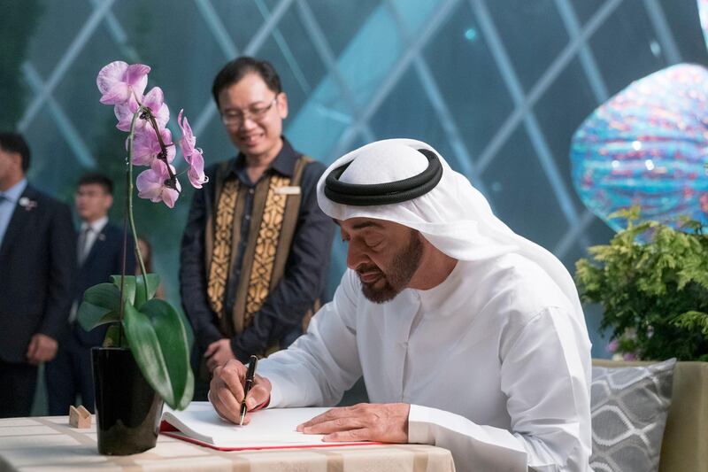 SINGAPORE, SINGAPORE - February 28, 2019: HH Sheikh Mohamed bin Zayed Al Nahyan, Crown Prince of Abu Dhabi and Deputy Supreme Commander of the UAE Armed Forces (R), signs a guest book at Gardens at the Bay. Seen with Felix Loh, Chief Executive Officer of Gardens by the Bay (2nd R).
( Eissa Al Hammadi for the Ministry of Presidential Affairs )
---