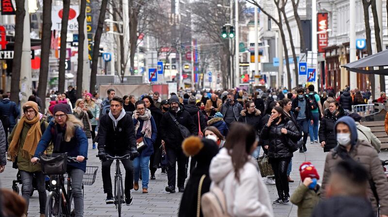 VIENNA, AUSTRIA - NOVEMBER 16: People walk along the popular Mariahilferstrasse pedestrian shopping zone the day before a strict nationwide lockdown is to go into effect on November 16, 2020 in Vienna, Austria. Starting tomorrow shops and businesses must close, schools may only operate remotely and people must stay indoors at home except for the most necessary outings. Additionally health authorities plan to soon launch mass Covid testing for the entire country. (Photo by Thomas Kronsteiner/Getty Images)