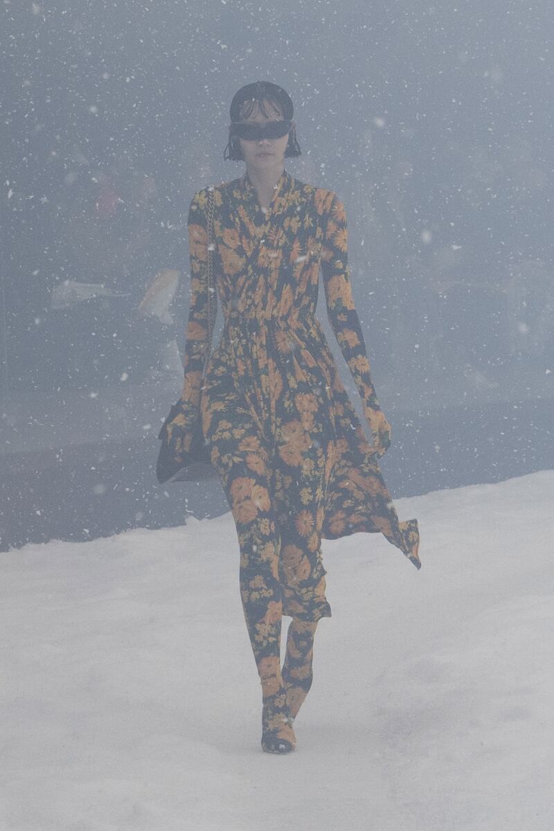 Despite the bleak set, this dress is covered in orange flowers.