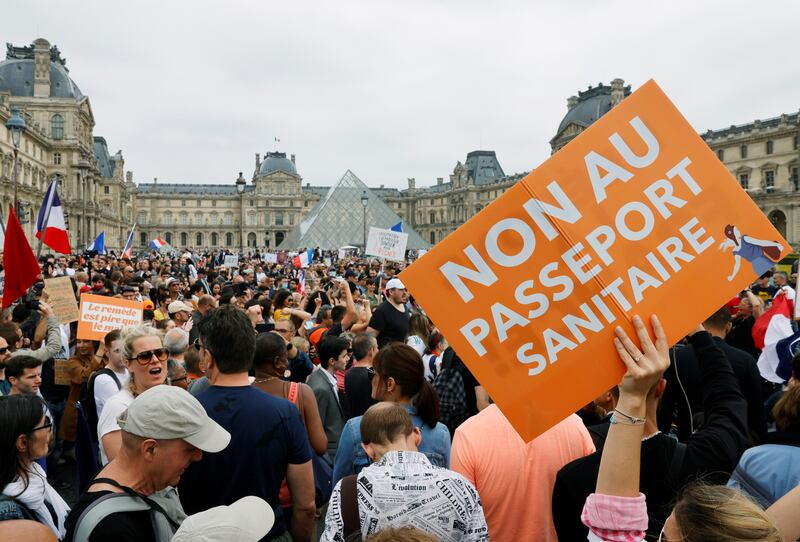 Demonstrators gather around the Louvre to protest against Covid-19 restrictions.