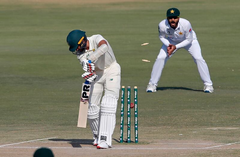 South Africa's Keshav Maharaj, front, is bowled by Pakistan's pacer Hasan Ali . AP