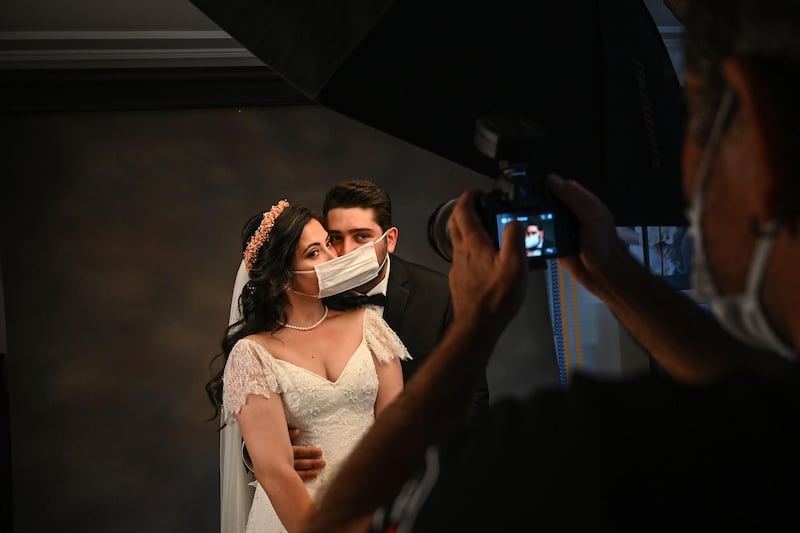 28-year-old Ayse Keles and her husband Alp Colak pose with disposable face masks for a wedding photo shoot in Istanbul, Turkey.