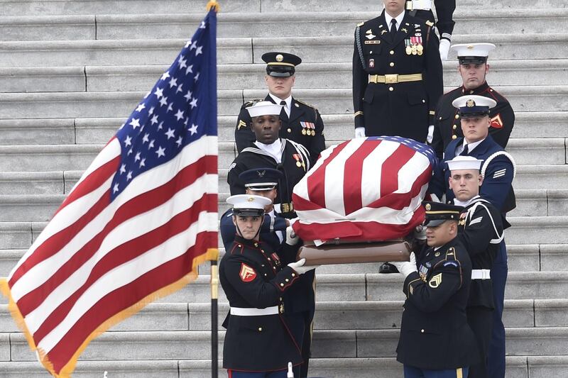 The casket departs the US Capitol. AFP