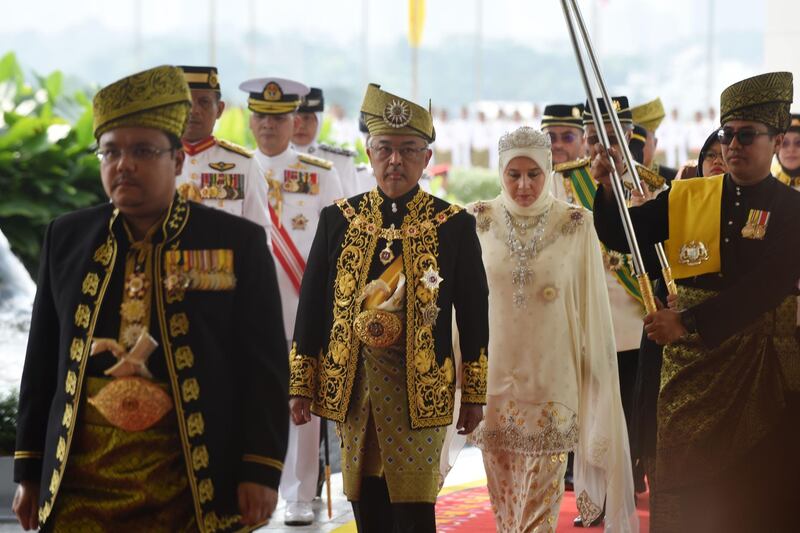 King Abdullah and Queen Tunku arrive for his royal coronation at the National Palace in Kuala Lumpur.