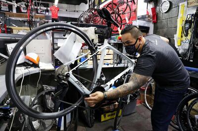DUBAI, UNITED ARAB EMIRATES , May 26 – 2020 :- Michael Philip Vazquez , Store manager from Philippines fixing the bicycle at the Revolution Cycles Dubai at Dubai Motor City in Dubai. He is wearing protective face mask as a preventive measure against the spread of coronavirus at the store. (Pawan Singh / The National) For News/Online/Instagram. Story by Kelly