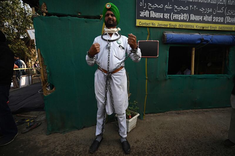 Farmer Kabal Singh chains himself at a protest site in Singhu.  AFP