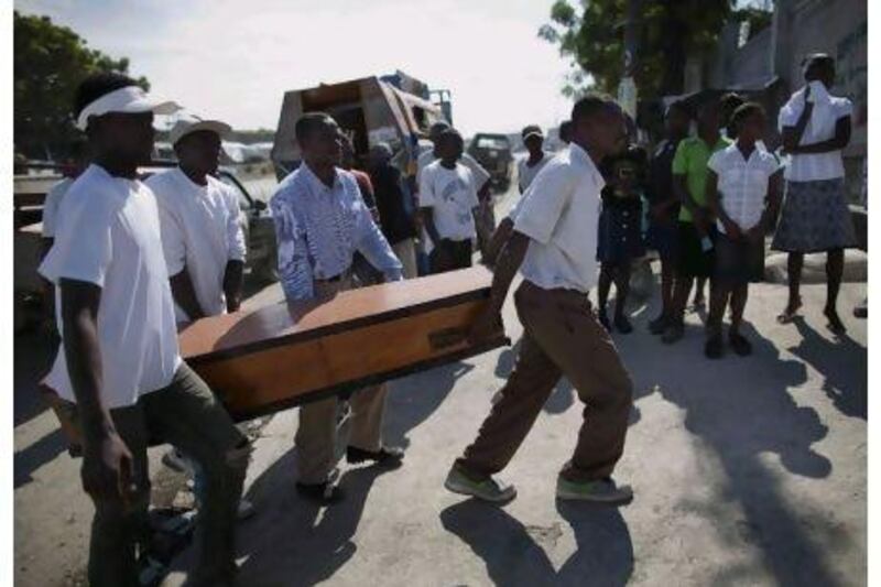 Relatives carry the coffin of eight-year-old Monitha Silney, who died of cholera in the Cité Soleil slum in Port-au-Prince.