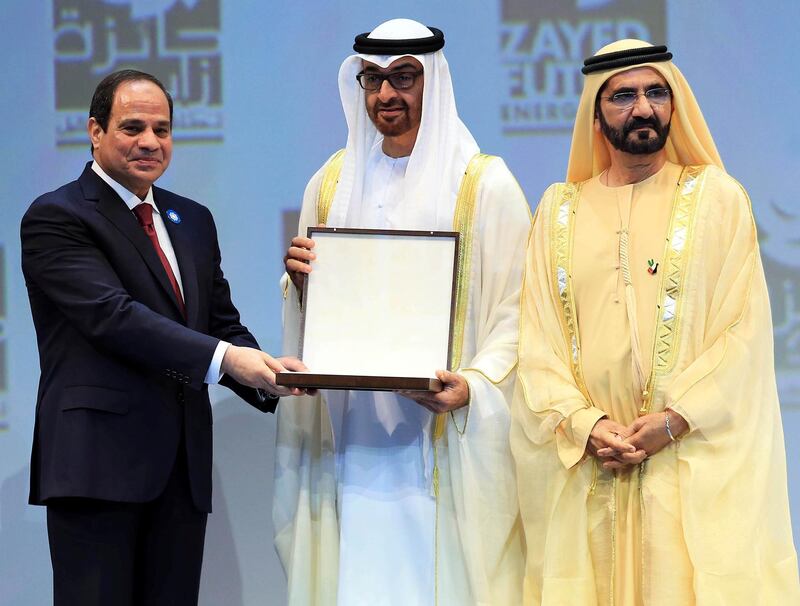 epa04568627 Sheikh Mohammad Bin Rashid al-Maktoum (R), Vice President and Prime Minister of UAE, stands by as Mohammad bin Zayed bin Sultan al-Nahyan (C), Crown Prince of Abu Dhabi and Deputy Supreme Commander of the UAE Armed Forces, presents the Egyptian President, Abdel Fattah al-Sisi (R), with an award during the Zayed Future Energy Prize Awards at the  the World Future Energy Summit 2015 (WFES) in Abu Dhabi, United Arab Emirates, 19 January 2015. Global leaders in policy, technology and business are gathering to discuss and develop new ways of thinking and shaping the future of renewable energy at the summit running from 19 - 22 January at the Abud Dhabi National Exhibition Center.  EPA/YOSHUA ARIAS *** Local Caption *** 51745663