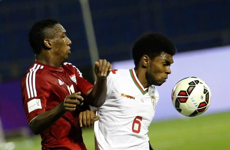 THe UAE’s Ahmed Khalil and Oman’s Raed Ibrahim Saleh fight for the ball. AFP