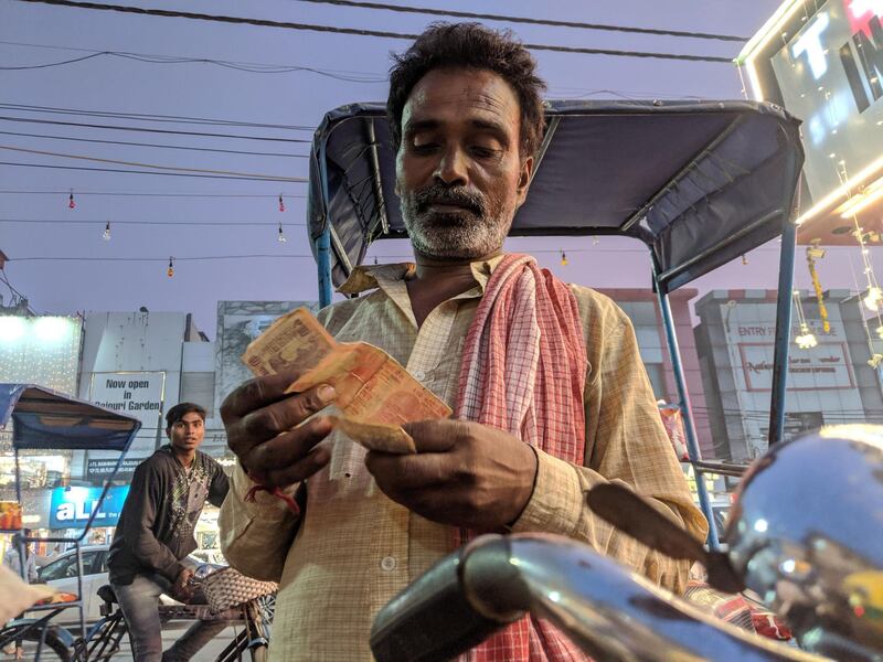 Ashok Mandal, 50, counting his earnings. Taniya Dutta for The National 