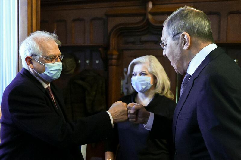 In this photo released by the Russian Foreign Ministry Press Service, Russian Foreign Minister Sergey Lavrov, right, and High Representative of the EU for Foreign Affairs and Security Policy Josep Borrell wearing a face mask to protect against coronavirus, greet each other prior to their talks in Moscow, Russia, Friday, Feb. 5, 2021. The European Union's top diplomat expressed hopes Friday that the COVID-19 vaccine developed by Russia will soon be used across the 27-nation bloc. During a visit to Moscow, EU foreign affairs chief Josep Borrell said the Sputnik V vaccine is "good news for the whole mankind." (Russian Foreign Ministry Press Service via AP)